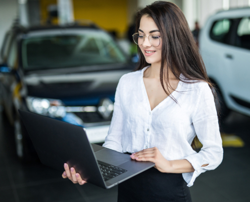 worker with laptop at dealership